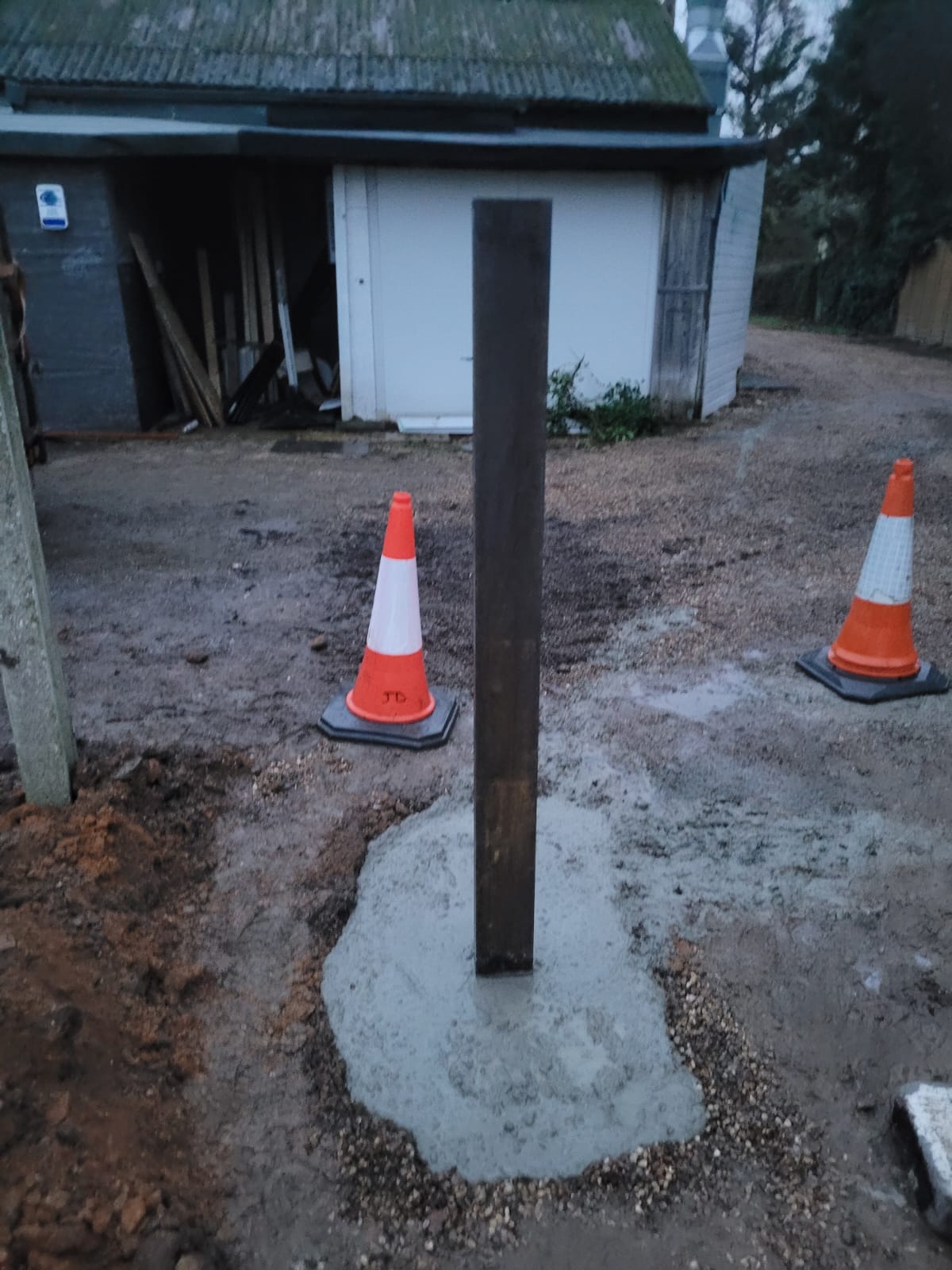 New steel gate post set in concrete