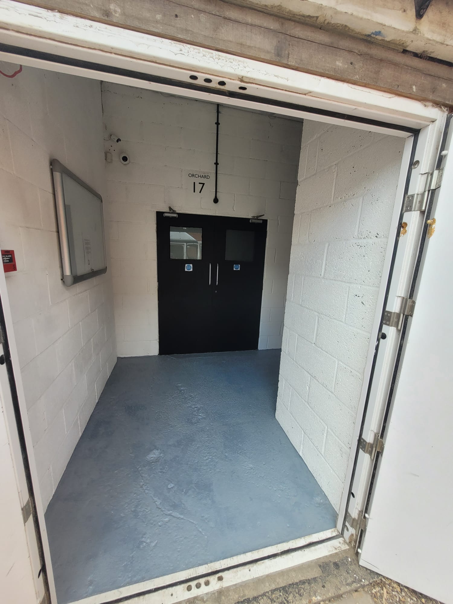 Unit entrance with freshly painted walls, floor and new fire doors