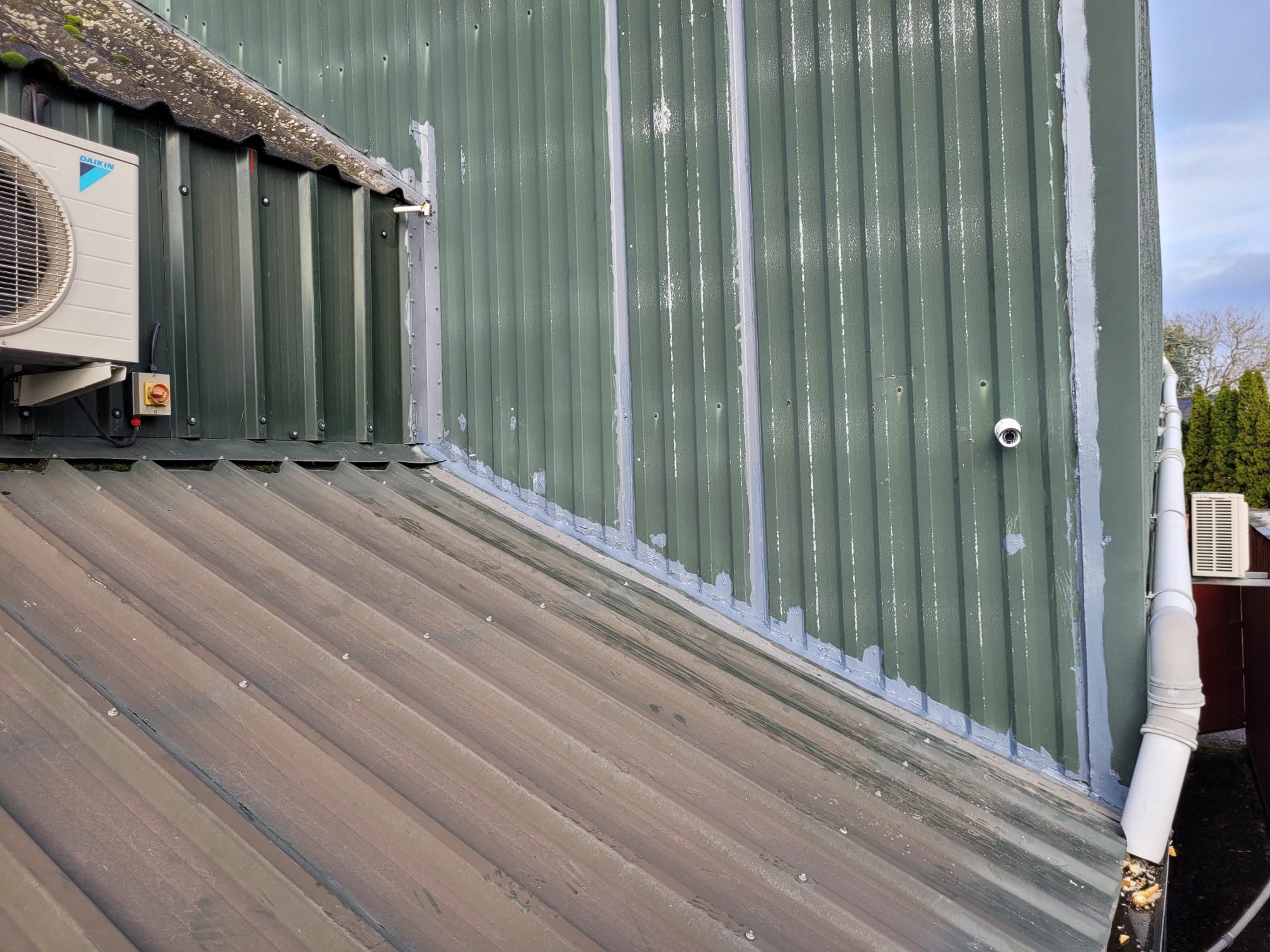 Cladding joint sealed and painted to stop roof leak